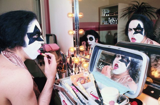 NEW YORK - APRIL 24:  Rhythm guitarist and co-lead singer Paul Stanley (L and R) and drummer Peter Criss (C, in mirror) of American hard rock band KISS at Make Up Center on April 24, 1974 in New York City.  (Photo by Waring Abbott/Getty Images)